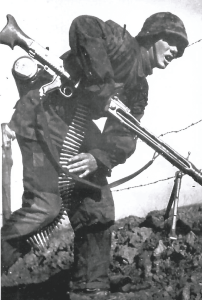 A Waffen SS MG 42 machine gunner of the infamous 12th SS (HJ) Panzer Division. The MG 42 was a sophisticated weapon of 7.62 mm calibre, much feared by Allied troops owing to its high rate of fire.
